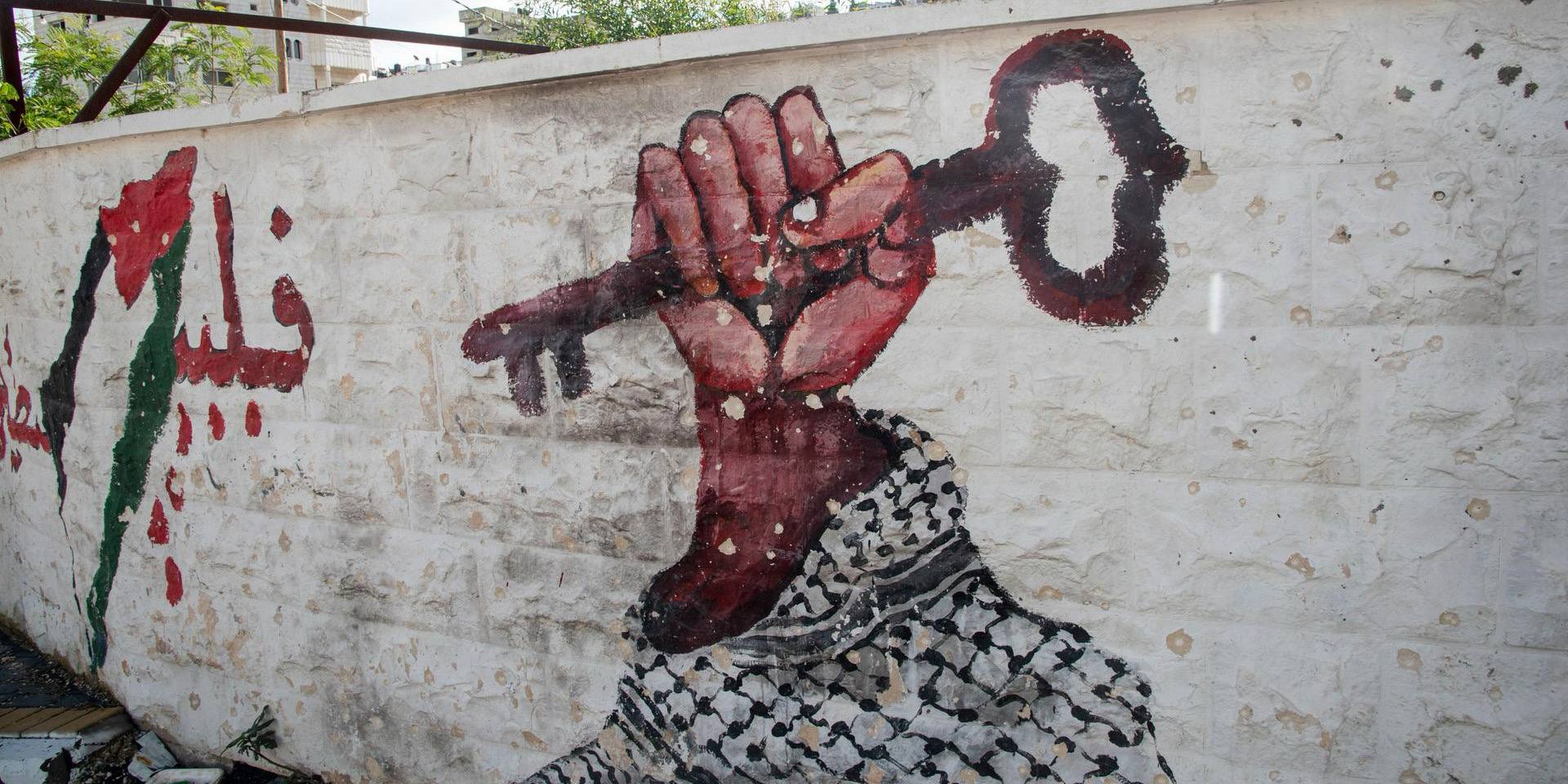 Graffiti an der Grenzmauer in Palästina. Kufiya mit Schlüssel. Symbole Palästinas